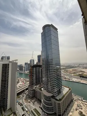 a tall skyscraper in the middle of a city at Damac MERANO LUX 2 bedroom 3 baths in Dubai
