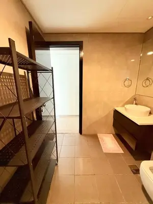a bathroom with a spiral staircase and a sink at Damac MERANO LUX 2 bedroom 3 baths in Dubai