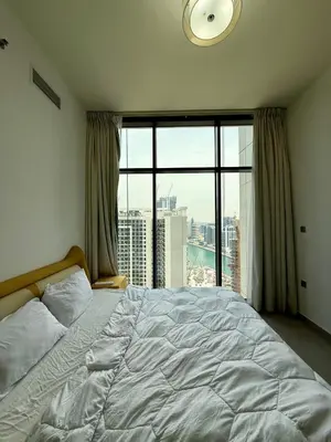 a bedroom with a large bed and a large window at Damac MERANO LUX 2 bedroom 3 baths in Dubai