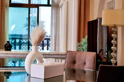 a vase with a brush and a box on a table at Full View Burj Khalifa and Fountains -Souk Al Bahar- Dream View holiday Home Rental in Dubai