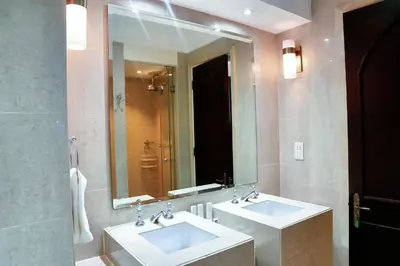 a bathroom with two sinks and a large mirror at Full View Burj Khalifa and Fountains -Souk Al Bahar- Dream View holiday Home Rental in Dubai