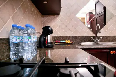 a kitchen with two bottles of water on a counter at Full View Burj Khalifa and Fountains -Souk Al Bahar- Dream View holiday Home Rental in Dubai