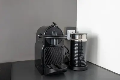 a kitchen counter with a coffee maker and a blender at New 1BR with Walk-in Wardrobe in Greenish Community in Dubai