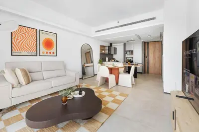 a living room with a white couch and a table at New 1BR with Walk-in Wardrobe in Greenish Community in Dubai