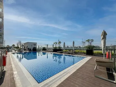 a large swimming pool in a building at Bright and Sleek Azizi Studio Prime Meydan Location in Dubai