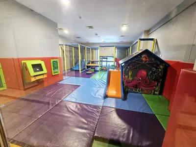a childrens play area with a slide in a room at SUNRISE HOMES - Spacious 1BR next to Marina Walk in Dubai