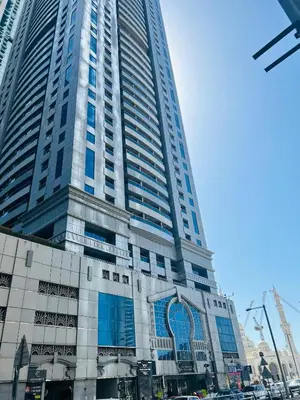 a tall building with a sign in front of it at SUNRISE HOMES - Spacious 1BR next to Marina Walk in Dubai