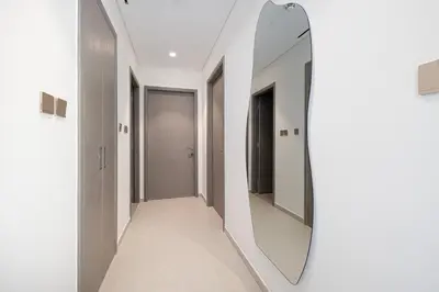 a mirror on a wall in a hallway at Great View from 63th Floor! Amazing Pool with Burj View! Grande Signature! in Dubai