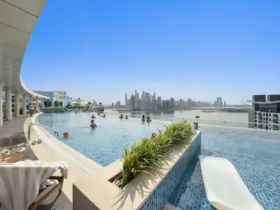 a swimming pool on the top of a building at Palm Jumeirah - Luxe Infinity Pool I Direct Beach Access in Dubai