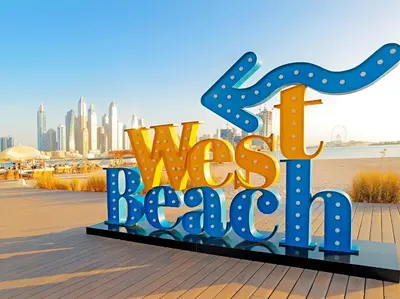 a sign that says was beach with a city in the background at Palm Jumeirah - Luxe Infinity Pool I Direct Beach Access in Dubai