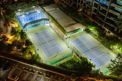 an overhead view of two tennis courts at night at Palm Jumeirah - Luxe Infinity Pool I Direct Beach Access in Dubai