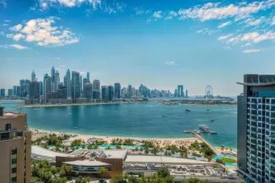 a view of the city of dubai from a skyscraper at Palm Jumeirah - Luxe Infinity Pool I Direct Beach Access in Dubai