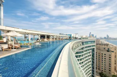 a swimming pool on the roof of a building at Palm Jumeirah - Luxe Infinity Pool I Direct Beach Access in Dubai