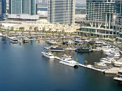 a group of boats docked at a marina in a city at KeyRock Living - Chic Reva 1BR with Pool Access in Dubai