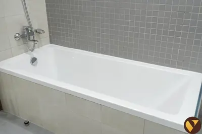 a white bath tub in a bathroom with tiles at Vogue Al Wasl 1 Residences Near Zabeel Park and World Trade Centre, Two Bedroom Apartment with Balcony and Dubai Frame, Access to all Amenities, Walkable to Max Fashion Metro Station in Dubai