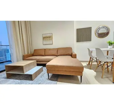 a living room with a couch and a table at Spacious 1BR Apartment in Binghatti Emerald JVC in Dubai