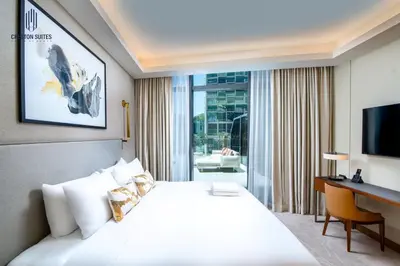 a hotel room with a large white bed and a desk at Luxury 1-BR at Dubai Opera Stay in Dubai