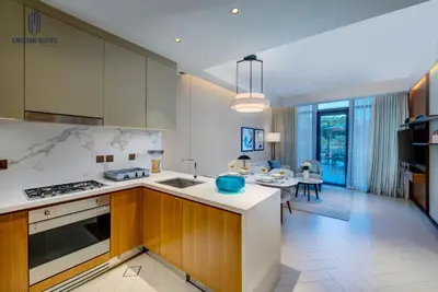 a kitchen with a counter and a dining room at Luxury 1-BR at Dubai Opera Stay in Dubai