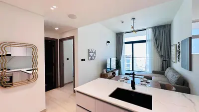a kitchen and living room with a couch and a table at Premium 1 Bed Apartment In Binghatti Venus in Dubai