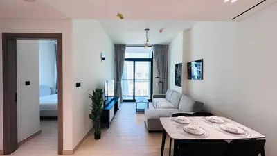 a living room with a couch and a table at OYO HOME 1457 Premium 1bed Apartment In Jvc Bh in Dubai
