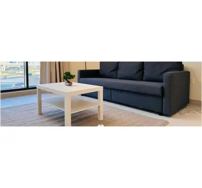 a living room with a couch and a coffee table at OYO HOME 1458 Premium 1bed Apartment In Jvc Be1005 in Dubai