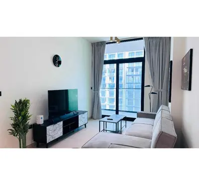 a living room with a couch and a flat screen tv at OYO HOME 1458 Premium 1bed Apartment In Jvc Be1005 in Dubai