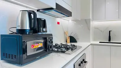 a microwave oven sitting on top of a stove in a kitchen at OYO HOME 1458 Premium 1bed Apartment In Jvc Be1005 in Dubai