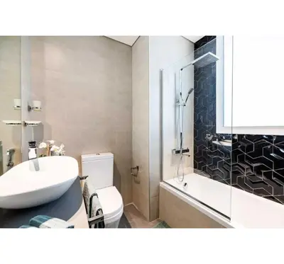a bathroom with a sink and a toilet and a shower at OYO HOME 1458 Premium 1bed Apartment In Jvc Be1005 in Dubai