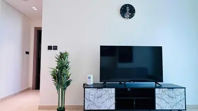 a flat screen tv sitting on top of a entertainment center at OYO HOME 1458 Premium 1bed Apartment In Jvc Be1005 in Dubai