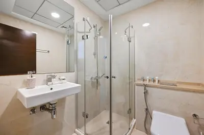 a bathroom with a shower and a sink and a shower at Serene Escape in Bustling Marina and JBR, Ensuite 2BR, Sky Garden Access in Dubai