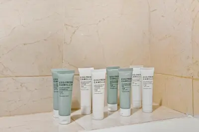 a group of four bottles of moisturizers on a shelf at Serene Escape in Bustling Marina and JBR, Ensuite 2BR, Sky Garden Access in Dubai