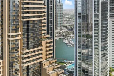an aerial view of a river between two tall buildings at Serene Escape in Bustling Marina and JBR, Ensuite 2BR, Sky Garden Access in Dubai