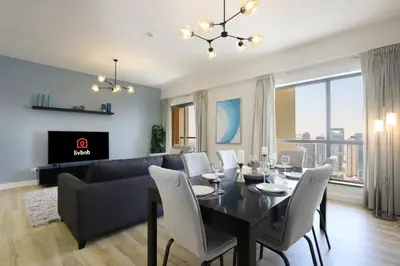 a living room with a table and a couch at Livbnb - Scenic 2BHK with Amazing Marina Views in Dubai