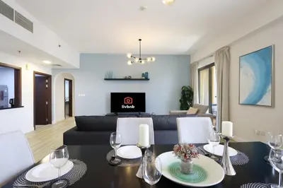 a living room with a black table and a couch at Livbnb - Scenic 2BHK with Amazing Marina Views in Dubai