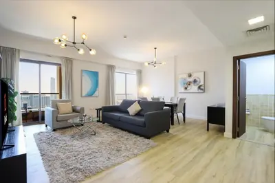 a living room with a couch and a table at Livbnb - Scenic 2BHK with Amazing Marina Views in Dubai