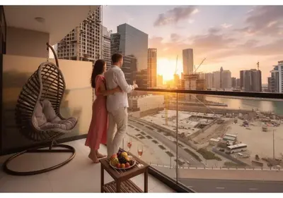 a couple standing on a balcony looking at the city at KeyRock Living - Zada 1BR with Pool & Gym Access in Dubai