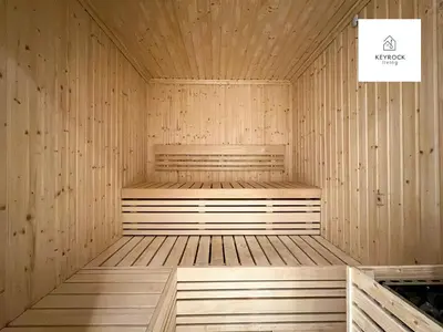 a wooden sauna with a bench in the middle at KeyRock Living - Zada 1BR with Pool & Gym Access in Dubai