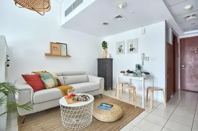 a living room with a couch and a table at Frank Porter - Lake Terrace Tower in Dubai