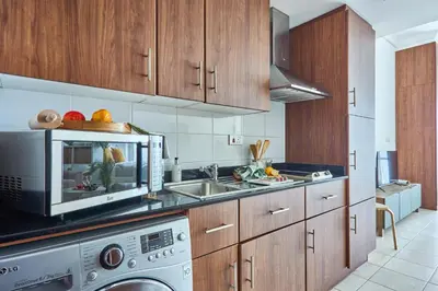 a kitchen with a sink and a microwave at Frank Porter - Lake Terrace Tower in Dubai