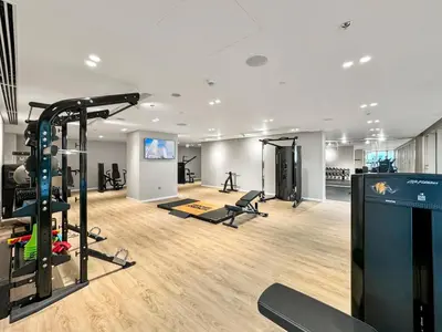 a gym with treadmills and exercise equipment in a building at Coastal Elegance 1-Bedroom in Grand Bleu in Dubai