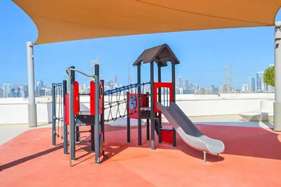 a playground with a slide on a roof at Stunning 1 Bdr Luxury District one in Dubai
