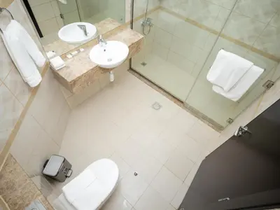 a bathroom with a toilet and a sink and a shower at Court Tower in Dubai