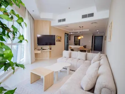 a living room with a couch and a tv at Court Tower in Dubai