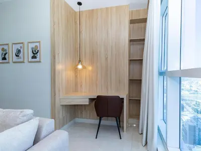 a room with a desk and a chair and a window at Court Tower in Dubai