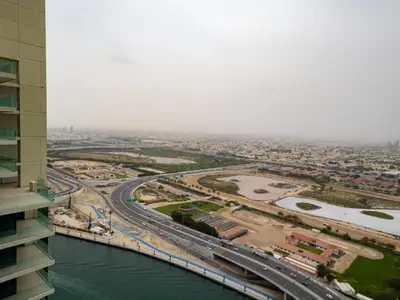 an aerial view of a city with a bridge and a river at Court Tower in Dubai