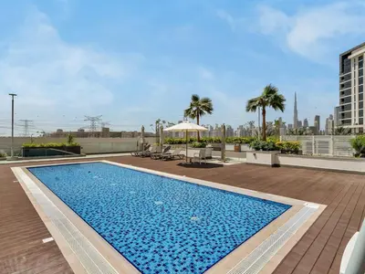 a swimming pool on the roof of a building at Stylish Azizi 1 Bedroom in Dubai