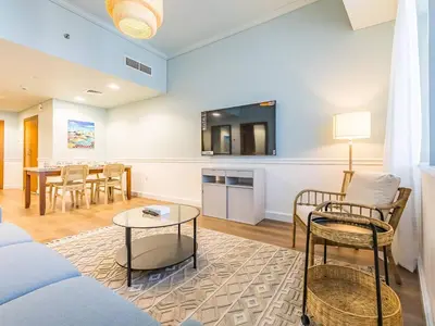 a living room with a couch and a table at Stylish 1-Bedroom with Panoramic Partial Sea View in Dubai