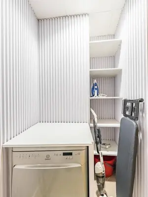 a kitchen with a stove and a shelf at Stylish 1-Bedroom with Panoramic Partial Sea View in Dubai