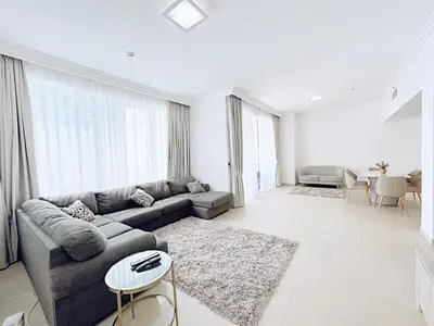 a living room with a couch and a table at Private Beach Access - Canal View in Dubai