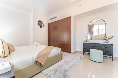 a bedroom with a large bed and a mirror at City View 2BR Just Steps from the Mall, Roxana Residence B, Jumeirah Village Circle by Deluxe Holiday Homes in Dubai